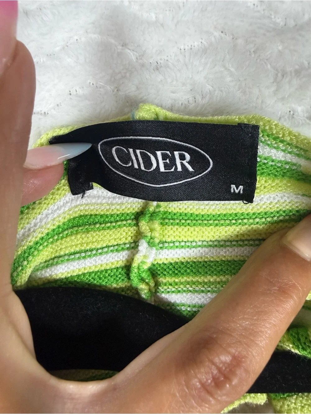 Cider striped halter top features a distinctive tie-back design vibrant green